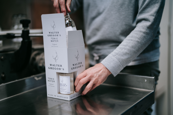 tonic bottles being packed into box