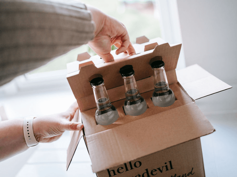 tonic bottles being packed into box