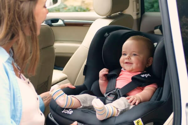 smiling baby in carseat