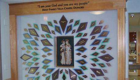 Oak cabinetry with frosted acrylic and backlit stained glass "diamonds." Design includes dimensional lettering and a museum-style box to display church icon. Donor names featured in gold engraving stock.