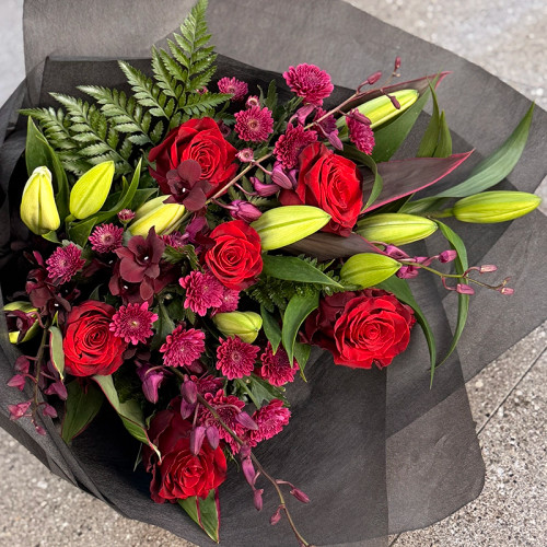 Red roses arrangement with dark pink, purples and reds in a passionate hand tied bunch. 

Perfect for your lover on Valentine's Day or just for a romantic surprise. 

 

The shown size is $180.00 but this can be ordered in assorted sizes. 