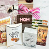 Close-up of Mother’s Day crate with gourmet snacks, chocolate, biscuits, and gift journal for mom