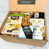 Close-up of appreciation gift box with cheese, crackers, marinated artichokes, olives, and mixed nuts