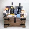 The Connoisseur Collection medium gourmet food and wine gift basket featuring Masi red and white wines, chocolates, Castello Brie and a vintage wooden trunk.