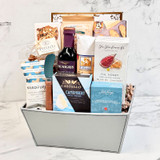 Gourmet gift basket with savory snacks, cheese spreads, cured meat, and premium food items