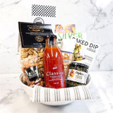 Pasta themed gift bowl with Italian ingredients, snacks, and savory treats arranged in glass bowl