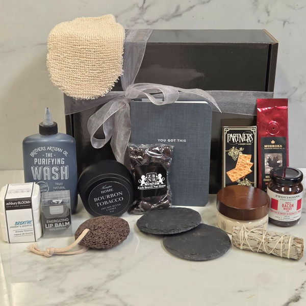 Men’s relaxation gift set, spa kit for him with face cleanser, pumice stone, sage, notebook, lip balm, crackers, whisky jam, and chocolate almonds