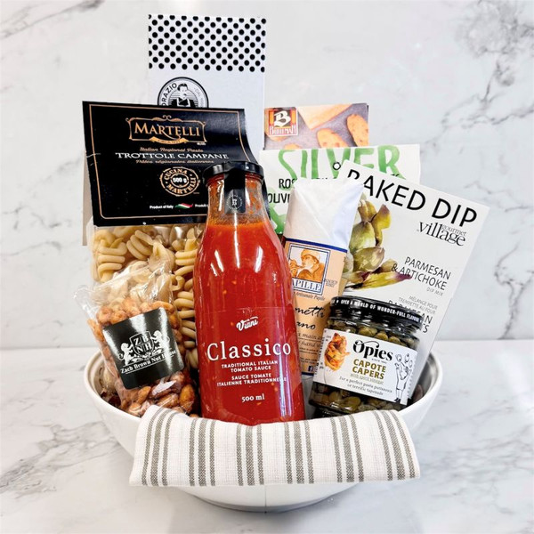 Gourmet Pasta Bowl gift set in glass bowl with pasta, tomato sauce, olives, sausage, and Italian snacks