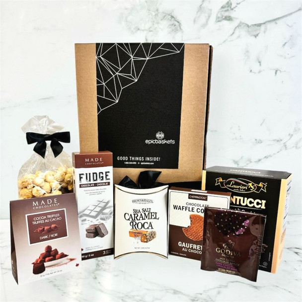 Chocolate gift basket featuring truffles, sea salt caramel roca, waffle cookies, and biscotti