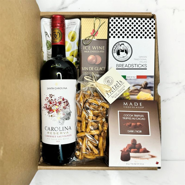 Wine gift basket featuring Cabernet Sauvignon, breadsticks, pretzels, olives, and ice wine chocolate