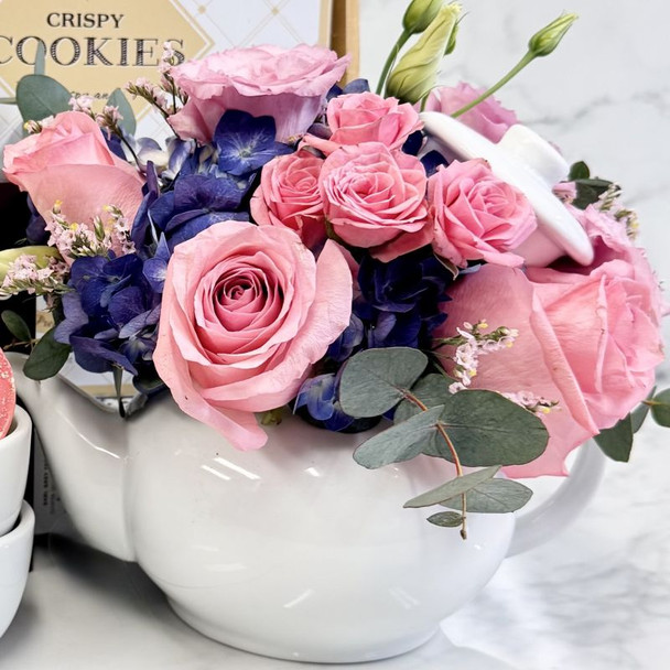 Mother’s Day gift set with pink and purple flower teapot, handle-free teacups, artisan sweets, and luxury tea box