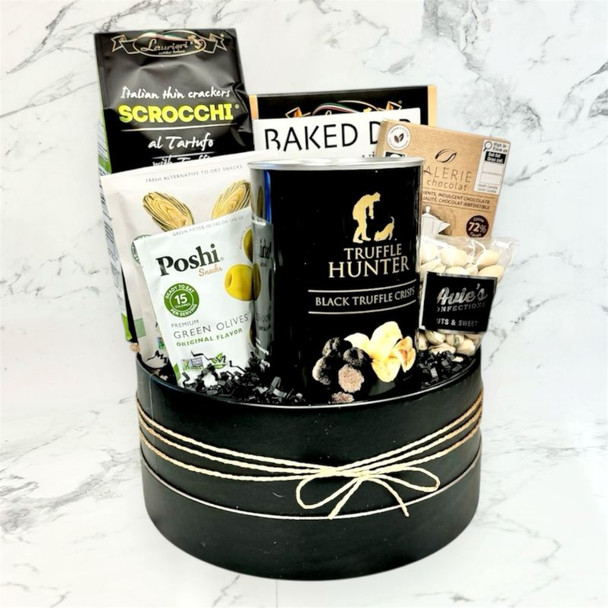 Vegan snack gift basket with savory treats, truffle crackers, and chocolate arranged beautifully