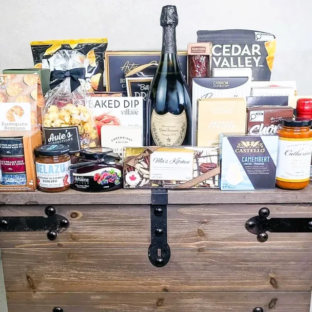 Luxury Champagne Gift Basket – The Connoisseur Collection- Elite with Dom Pérignon Brut Vintage Champagne and gourmet specialties in a large wooden trunk.