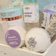 Detailed view of spa basket with lavender soap, eye mask, bath mitt, and calming wellness items