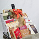 Gourmet Thanksgiving gift basket featuring cheese, wine, biscuits, chocolate and kitchen towels