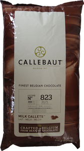 Front of Callebaut 823 33.6% milk chocolate callets bag, 22 lbs, showing the tan product label with the Belgian Callebaut branding.