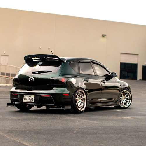 Rear low-angle shot of a Gen 1 Mazdaspeed3 with installed rear diffuser – Highlights aggressive styling and ground-hugging look.