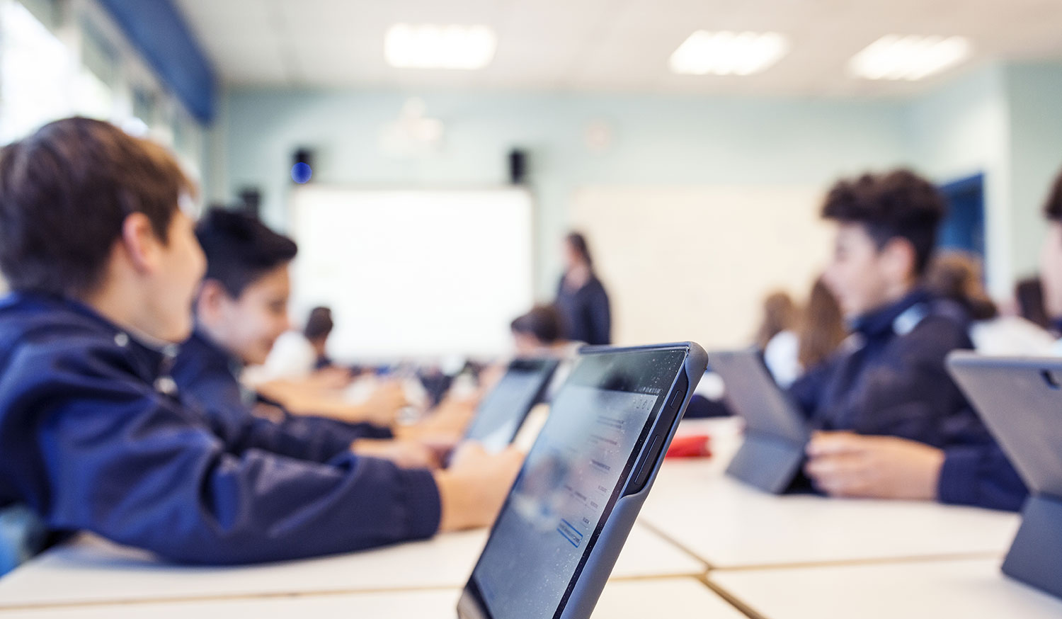 High school boys in class with Tablets