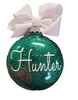 green glitter name Christmas ornament hanging on tree