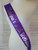 purple party sash with silver lettering