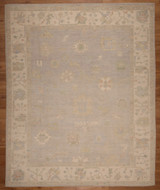 Room-sized hand-knotted rug from Pakistan with a light blue background and cream field 8'"x9'9"