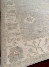 Room-sized hand-knotted rug from Pakistan with a light blue background and cream field 8'"x9'9"