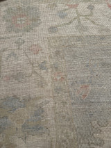 Room-sized hand-knotted rug from Pakistan with a light blue background and cream field 8'"x9'9"