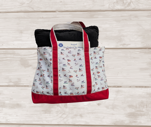Weekender canvas tote with red trim and skiing dogs, made from recycled polyester. About 23.5" wide X 13.5" tall.