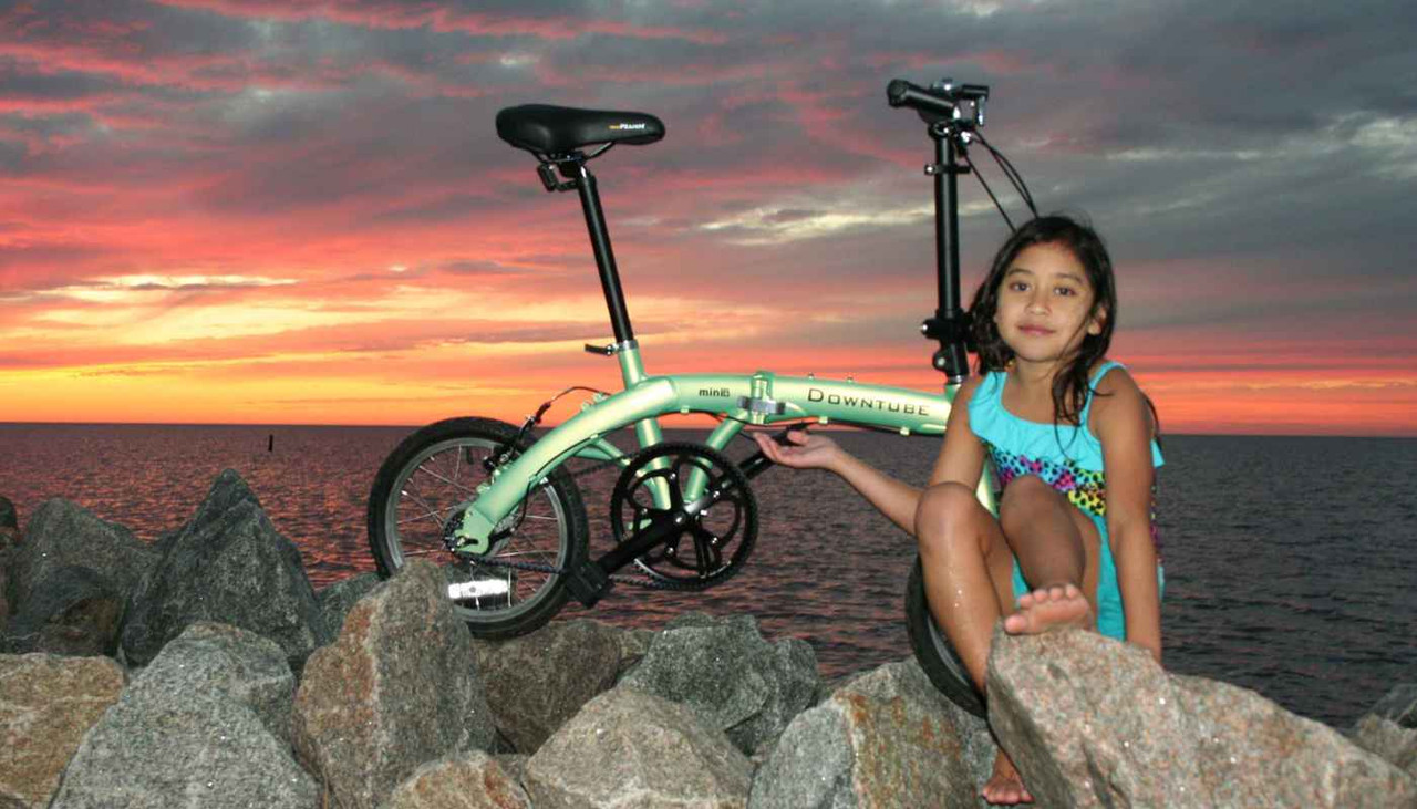 mini folding bike during sunset with little girl