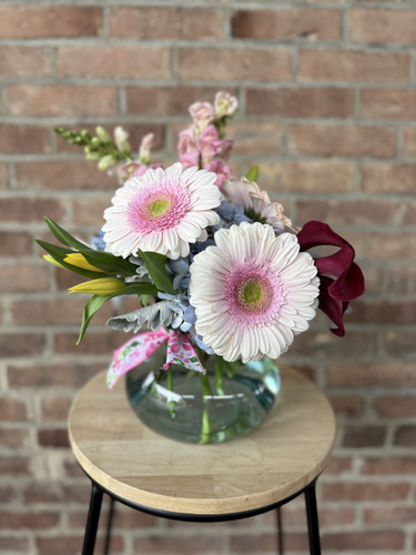 Send mom a pretty posey vase is designed with a variety of spring florals. 
Colors and flower options may vary