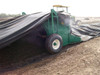 Compost Windrow Turner turning compost covered by a Windrow Cover