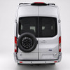 Surco TF300 black driver-side rear door tire carrier on white Ford Transit van holding a mounted spare tire