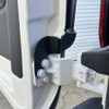 Close-up of Surco TF300 black tire carrier mounting detail on Ford Transit lower driver-side rear door hinge