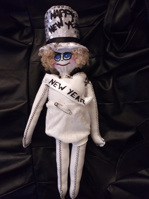 Baby New Year" collectible doll.• Classic New Year infant doll complete with a soft, plush white diaper and a statement safety pin.