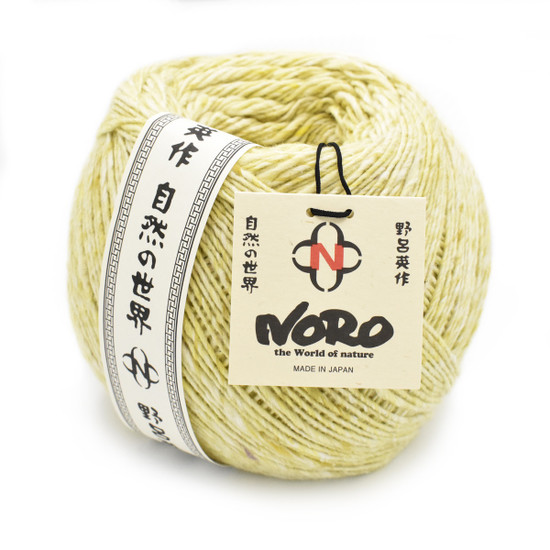 Skein of luxury Noro Akari Solo yarn in soft yellow with Japanese label and attached product tag.