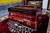 side view of national music Special Edition Mysterious Red 2 Line Harmonium side view of national music Special Edition Mysterious Red 2 Line Harmonium