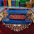customer name written on blue-black harmonium with golden colored decorative work on corners