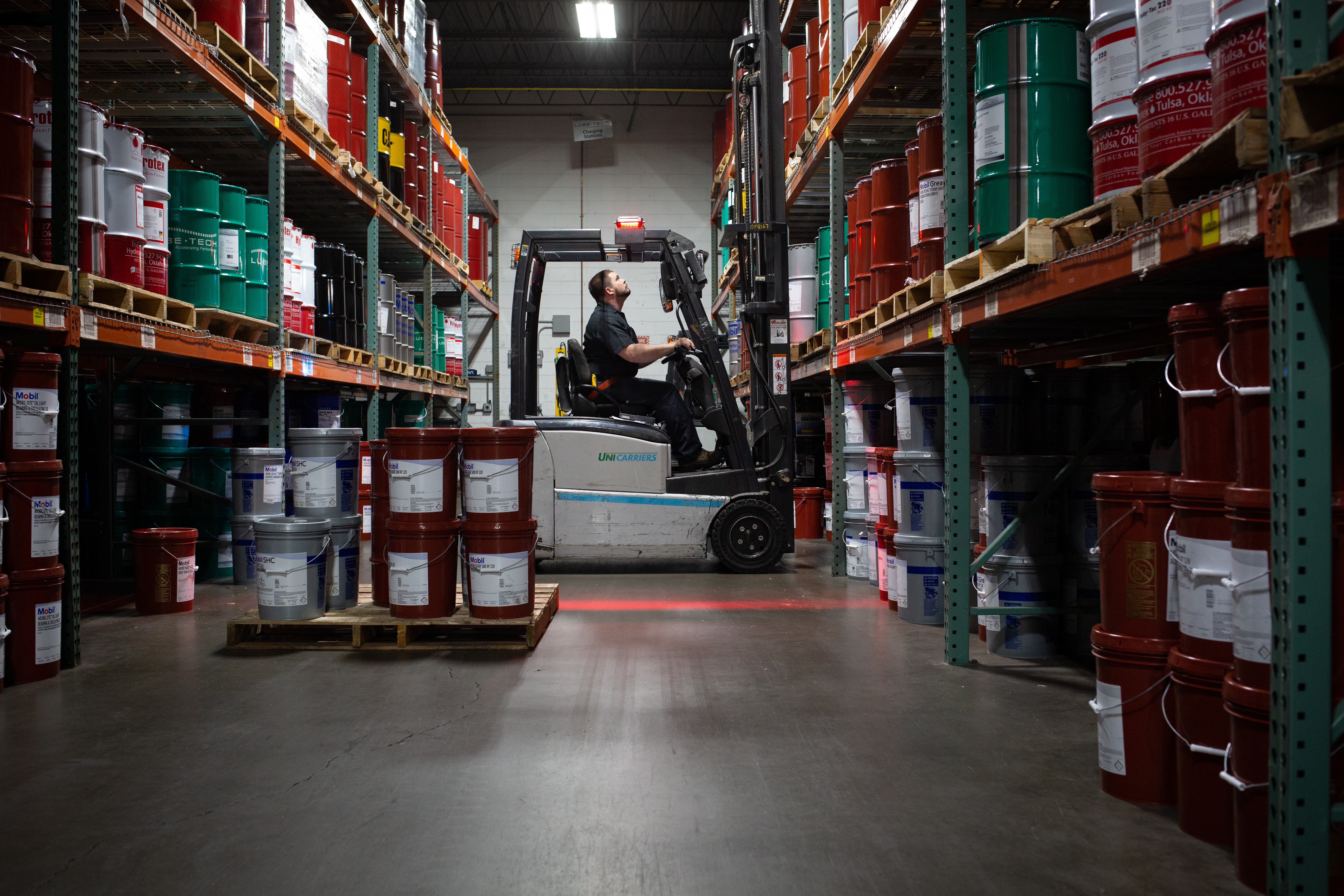 Lubetech employee operating a forklift inside a warehouse