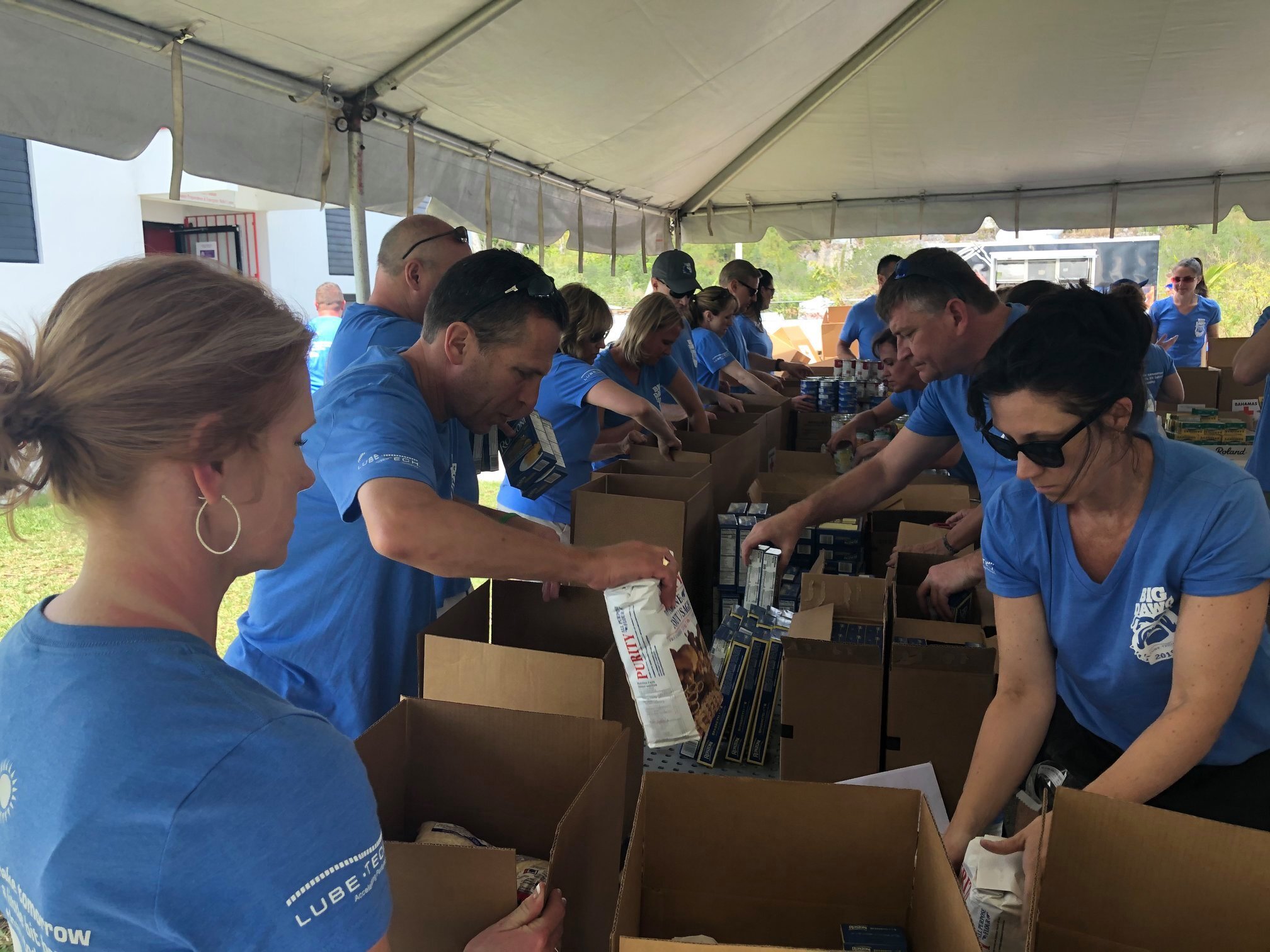 Lubetech employees packing items into boxes