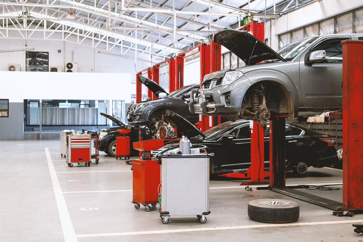 A row of car lifts in a shop