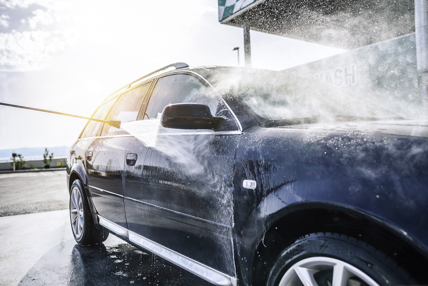 power washing a black SUV