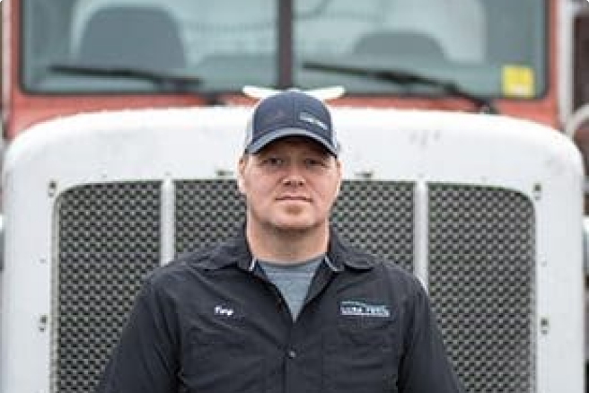 Driver standing in front of a truck