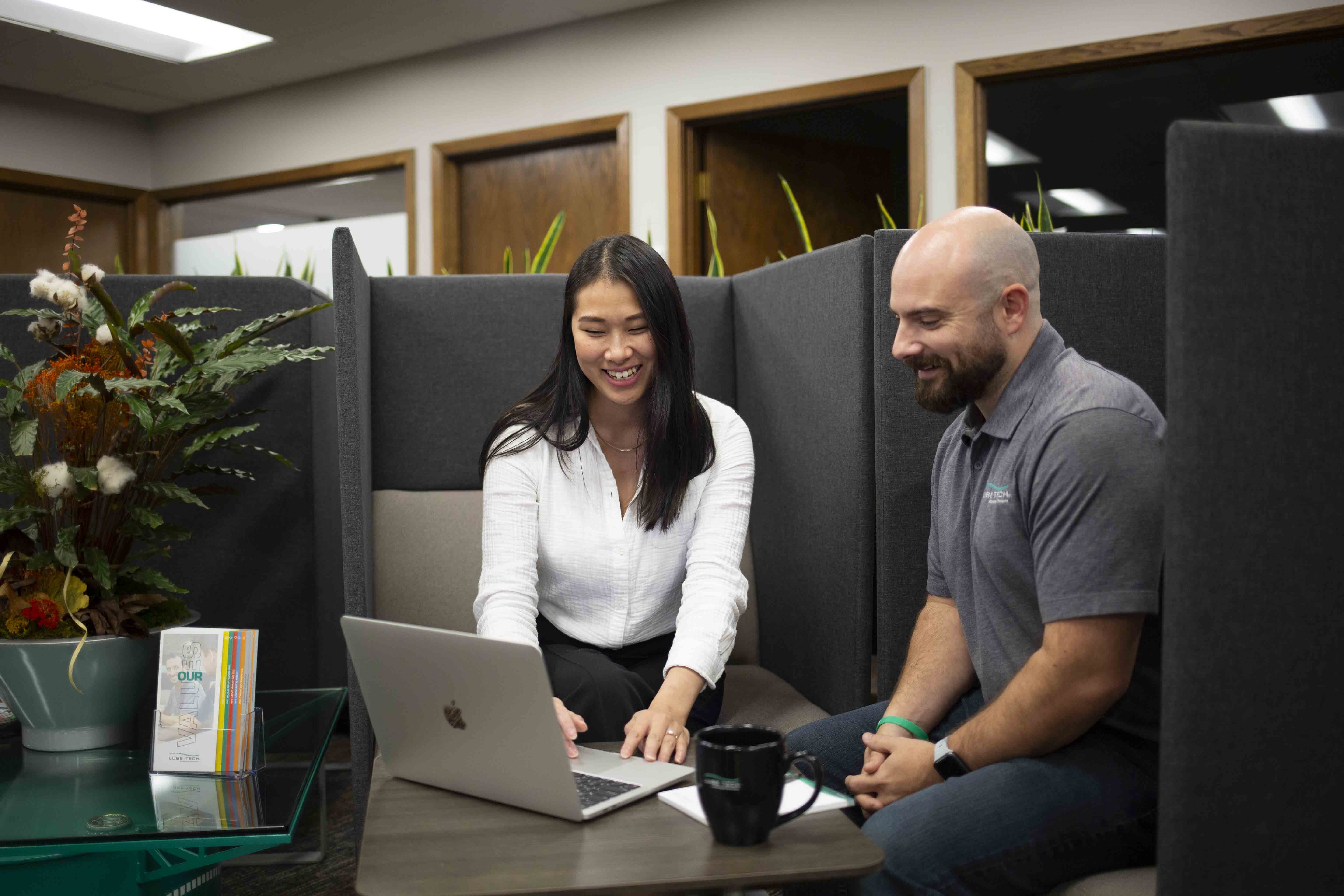 Two people looking at a laptop computer