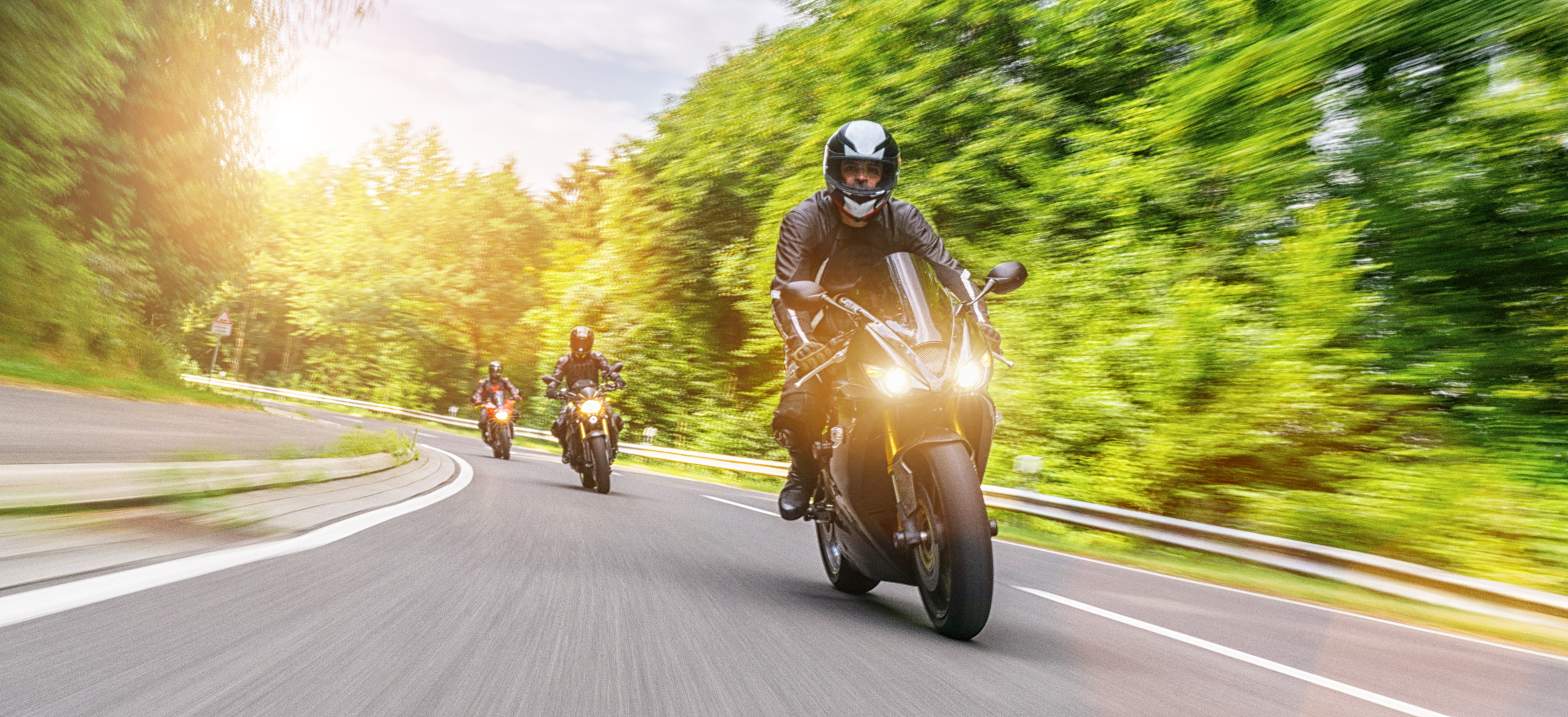 3 Motorcycles riding down a curvy road