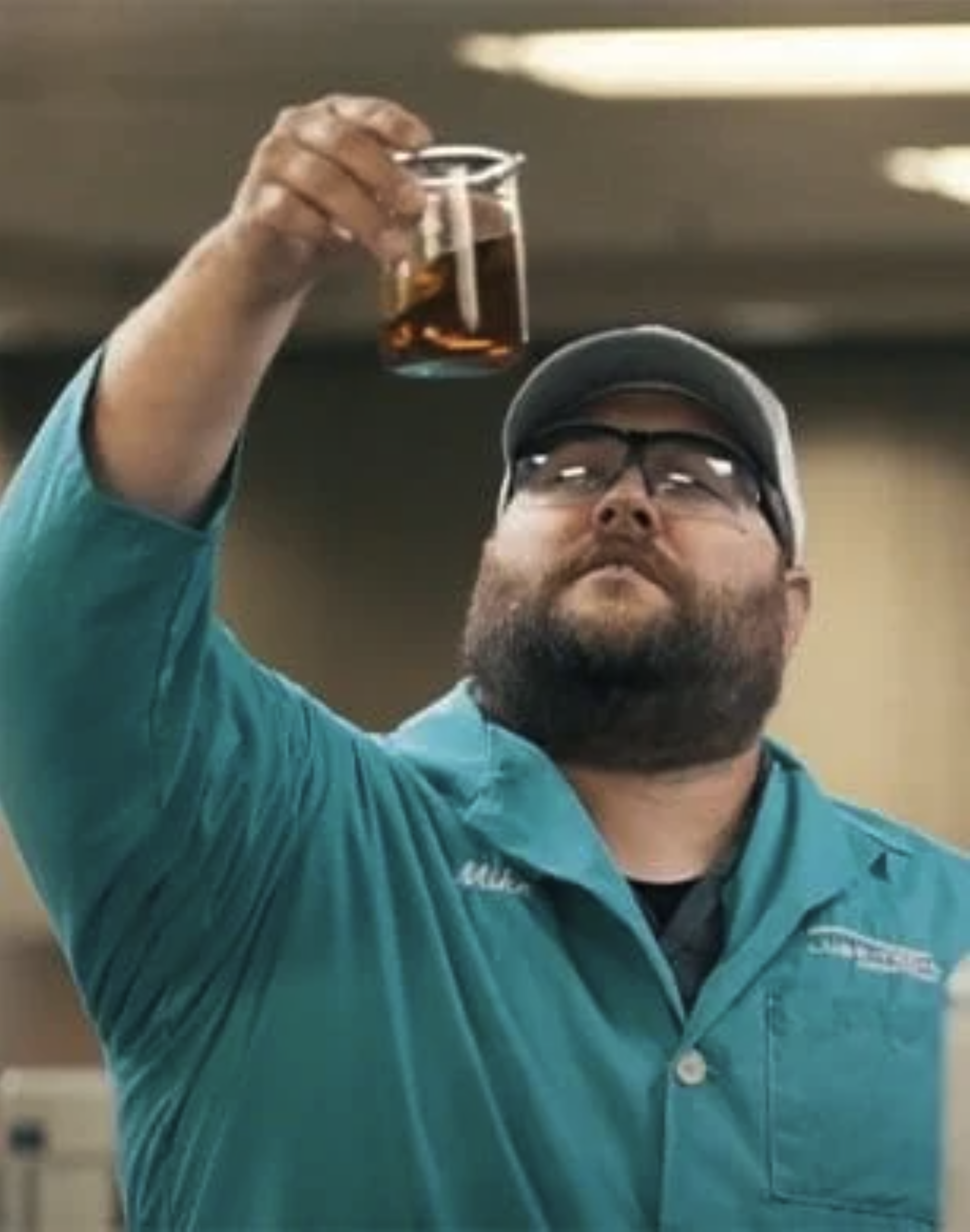 Technician looking at lubricant