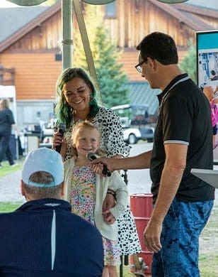 Girl speaking at a event surrounded by people