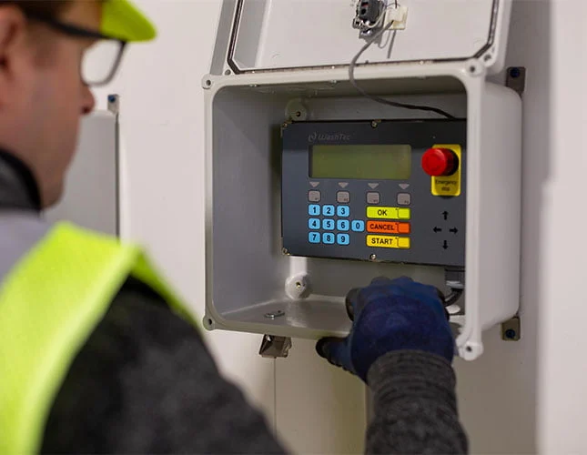 Technician adjust setting on equipment