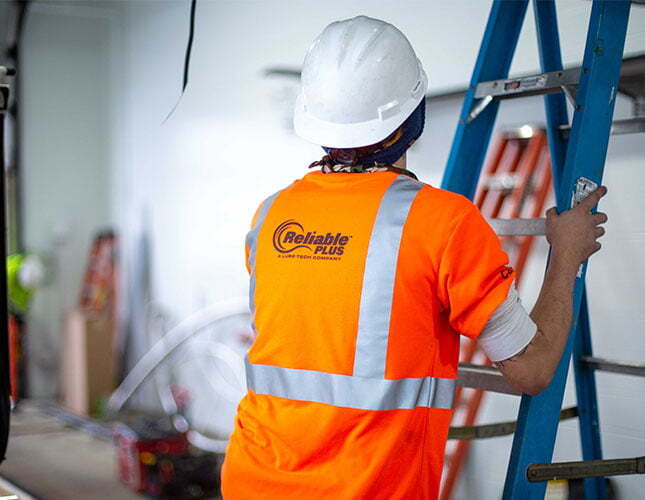 Technician climbing ladder