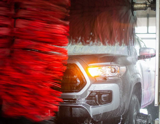 pickup truck getting washed in automatic car wash