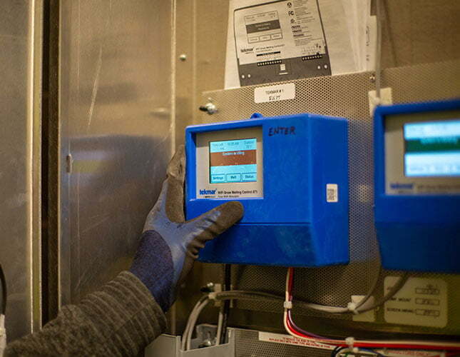 Technician changing setting on automatic car wash